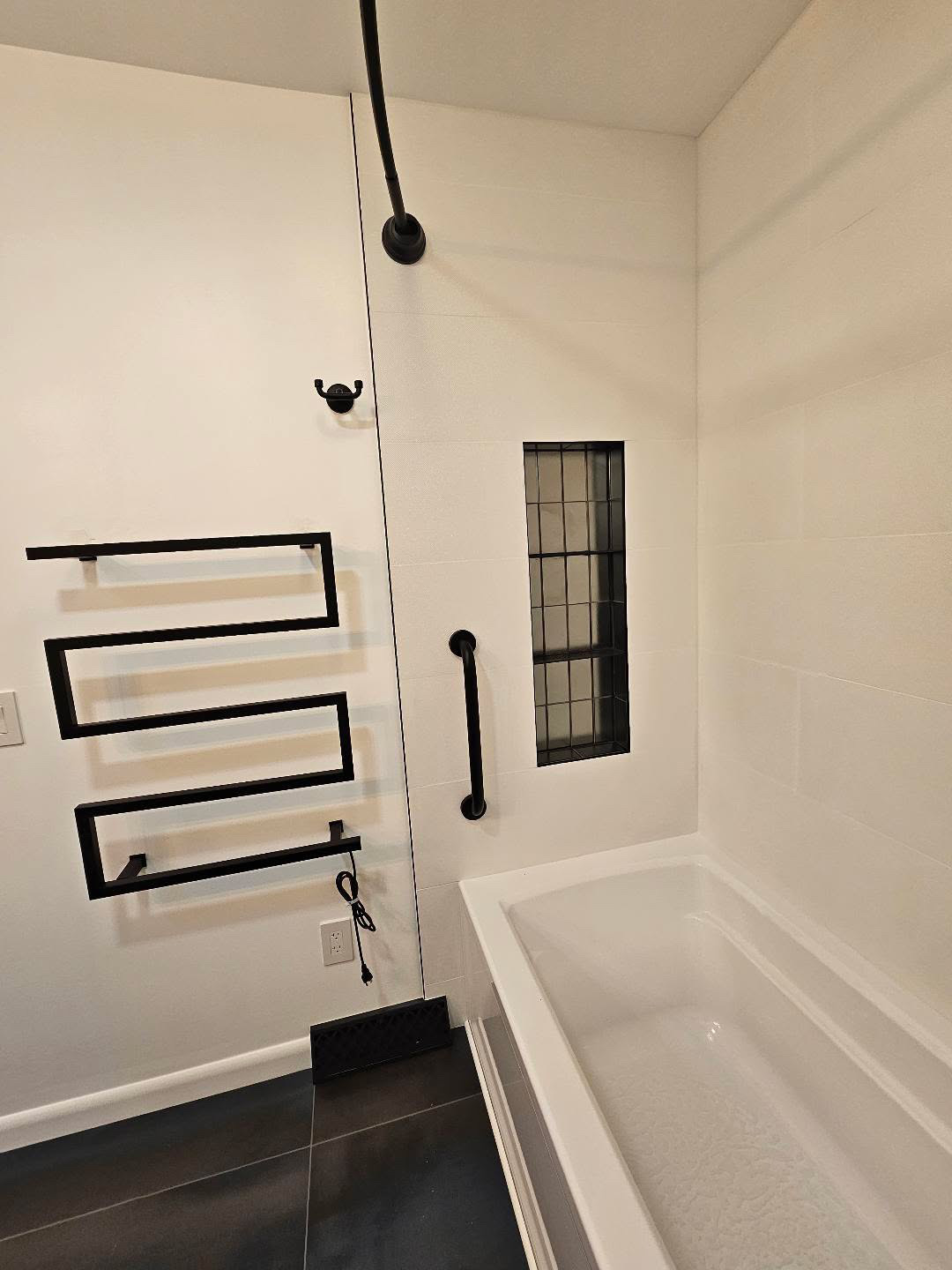 Bathroom with white subway wainscot and dark floor