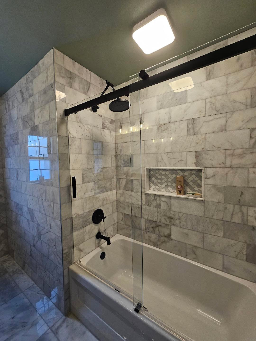 Marble-look subway tile tub and shower surround