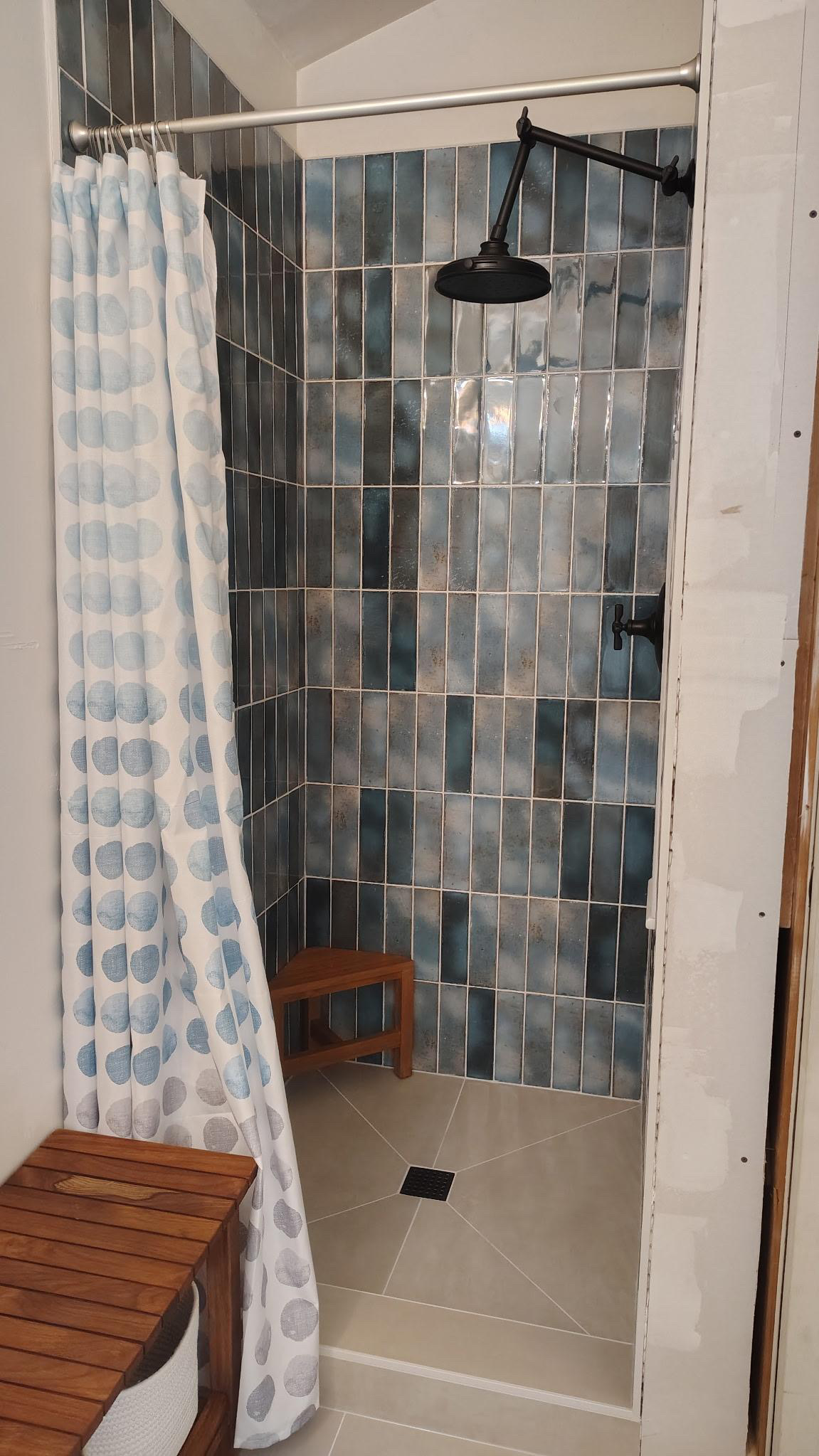 Walk-in shower with vertical stacked blue tile
